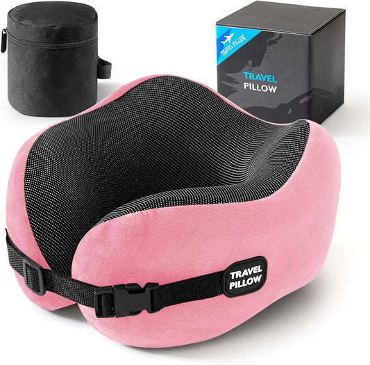 Pink and black travel pillow with adjustable strap labeled "Travel Pillow" next to a carrying case and packaging box, designed for comfort with Neck Pillow Memory Foam - 100% Pure Comfort and Support.